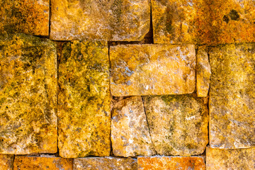 Rough yellow brick wall texture pattern in Coba Mexico.