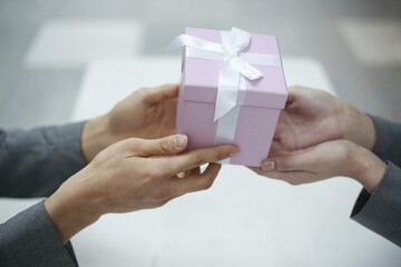 Cropped Hands Of Couple Holding Gift Box
