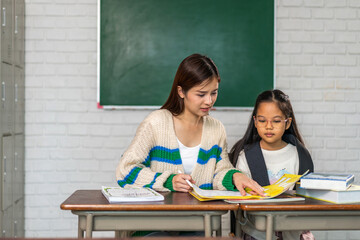 Portrait asian teacher help teaching children student having fun activity learn, study with book making homework, student, education, knowledge, elementary, lessons, kid, child, in classroom at school