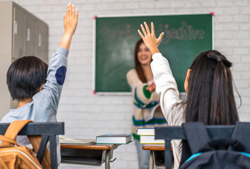 Portrait asian teacher teaching and children student raising hands for question, activity learn, study with book, student, education, knowledge, elementary, lessons, kid, child, in classroom at school