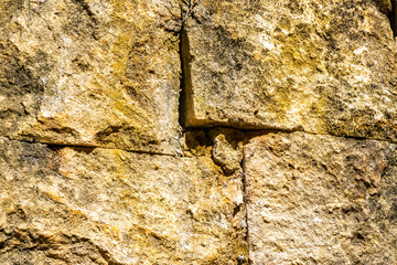 Rough yellow brick wall texture pattern in Coba Mexico.