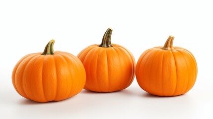 Obraz premium Close-up realistic photo showcasing three bright orange pumpkins on a white background Generative AI