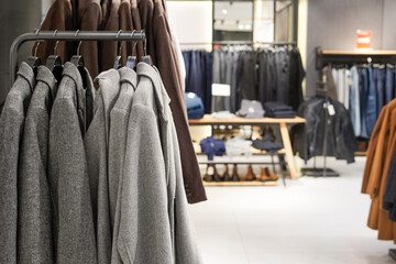 Men's casual clothing store, gray jackets on the hangers