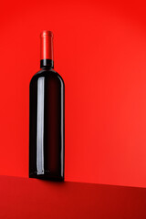 Red wine elegance: Wine bottle against vibrant red background
