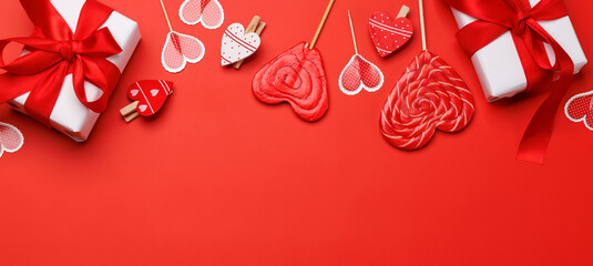 Heart lollipops: Sweet treats on a red backdrop with text space