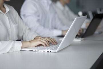 Business people using laptop in meeting