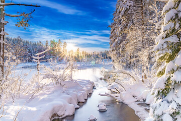 River flowing through the winter forest in Sweden