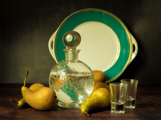 Antique-style still life with pears and alcohol vodka . - 704461363