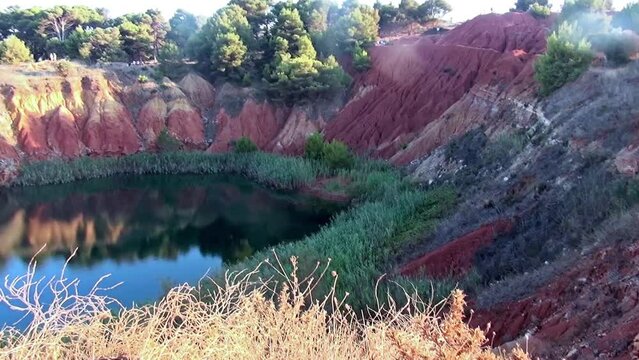 The small lake of the former bauxite quarry in Otranto, Lecce, Italy.