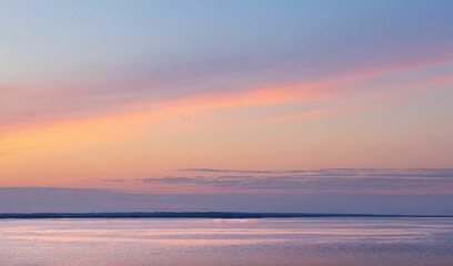 Fototapeta na wymiar A soft sunset over a serene horizon with pastel colors.