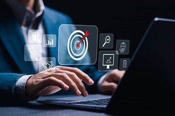 Businessman use laptop with target icons for business objective. Strategic planning for business...