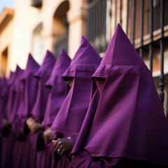 Holy Week , group of penitents holding a cross dresses  with vivid colors
