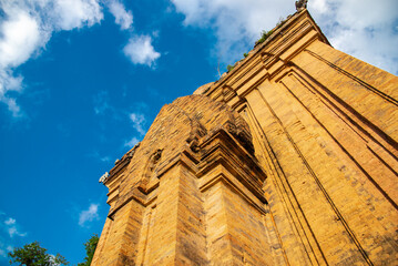 Looking up North Tower or Thap Chinh at about 28 meter high of Ponagar Cham Towers with terraced pyramidal roof, bricks under sunny blue clou sky, religious attractions in Nha Trang, Vietnam - obrazy, fototapety, plakaty