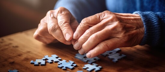 old woman's hands are putting together a puzzle