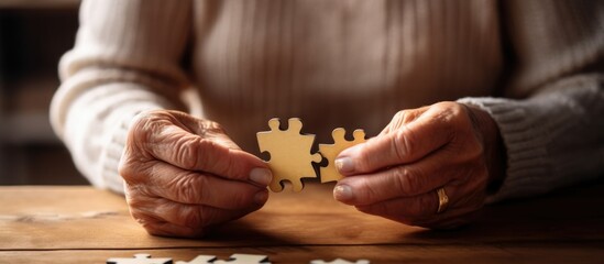 old woman's hands are putting together a puzzle