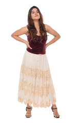 Naklejka premium Young Indian girl wearing red velvet top and creamy and lacy long skirt with elegant pose and expression
