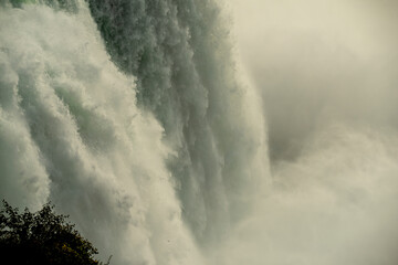   Powerful streams of rushing water of Niagara Falls. Close-up.