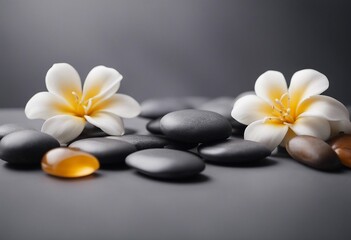 Spa gray background with massage stones exotic flowers and copy space