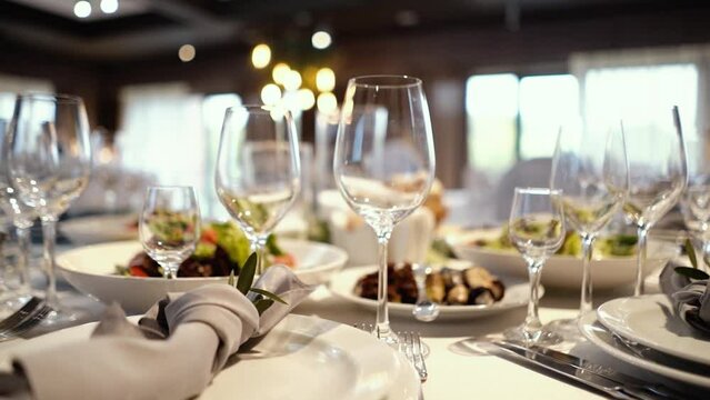 decoration of the wedding presidium for the banquet, table of the bride and groom, many delicious dishes on the festive table, close-up