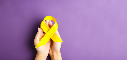 yellow Ribbon against white background for endometriosis awareness campaign, suicide prevention , Childhood cancer. - obrazy, fototapety, plakaty