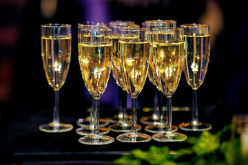 Glasses of champagne on blurred background at party event. vacation, birthday celebration, wedding ceremony, corporate holiday party social event background.