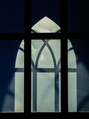 Church window in the rays of the sun.