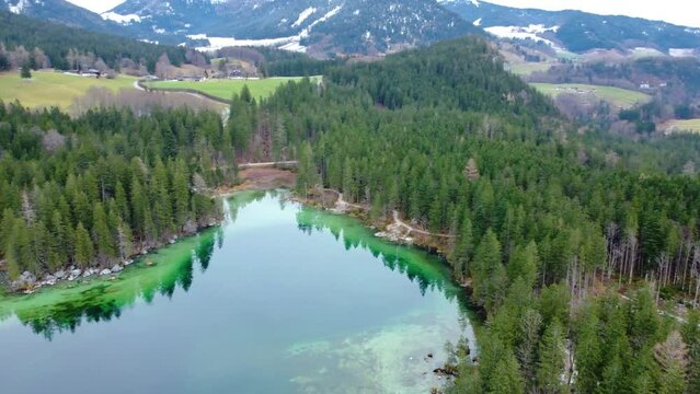 Aerial view over crystal clear water at the Berchtesgaden Hintersee lake and Alps Mountain in Germany