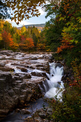 Indian Summer in New Hampshire, USA. A scenic view of the Swift river flowing during autumn.