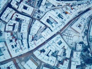 white snowy winter over European old town Lublin, snow storm and snowfall at ancient district of Poland, Europe aerial