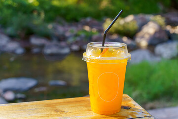 A glass of orange juice has thinly sliced orange pulp. placed on top Suitable for drinking to cool off. Refreshing, welcome drink, sitting in the cafe
