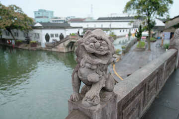 lion statue in front of Chinese building