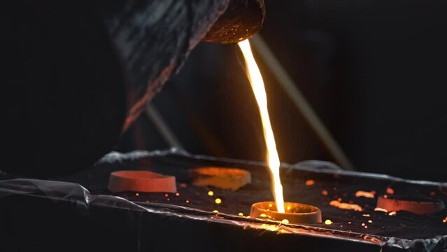 Liquid metal production close up. Steelmaker works in a foundry in furnace. Liquid metal production