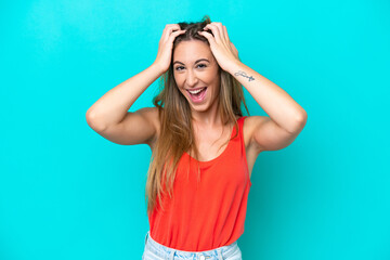 Young caucasian woman isolated on blue background with surprise expression