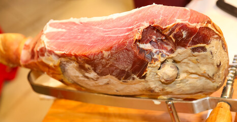 Big Piece of  raw cured ham for sale at a deli