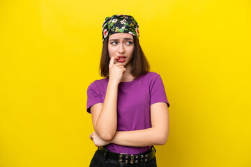 Young Ukrainian woman isolated on yellow background nervous and scared