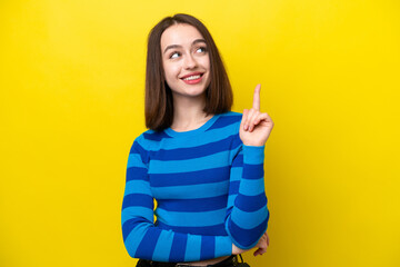 Young Ukrainian woman isolated on yellow background pointing up a great idea