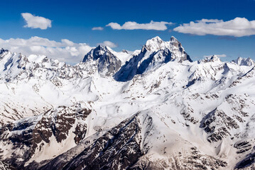 Winter mountains of the Caucasus on a sunny day. Panoramic view - 704528943