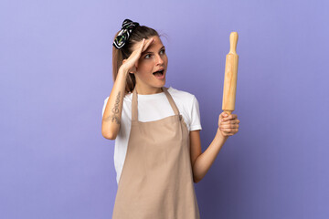 Cooker Slovak woman isolated on purple background with surprise expression while looking side