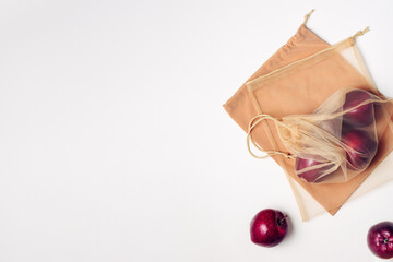 Red apples in a reusable mesh bag.