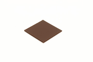 Thin square piece of chocolate isolated on white background