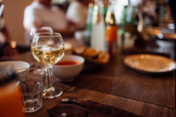 Banquet hall with tables and chairs. No people. In foreground is bottle of juice