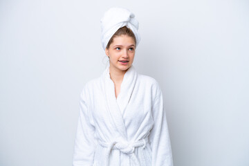 Teenager Russian girl in a bathrobe isolated on white background thinking an idea while looking up