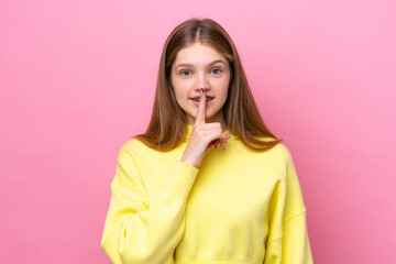 Teenager Russian girl isolated on pink background showing a sign of silence gesture putting finger...