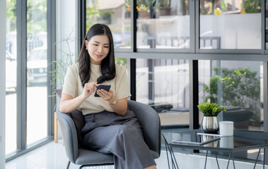 Successful businesswoman financier investors use smartphone to communicate remotely over the internet or video call to set challenging business goals and ready to achieve targets from work office