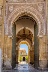 Arched entry of the Mezquita Cathedral in Cordoba, Spain - 704536708