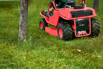 Professional grass cutting on lawns with a mini tractor lawn mower. 