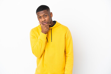 Young latin man isolated on white background having doubts