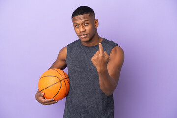 Young basketball latin player man isolated on purple background doing coming gesture