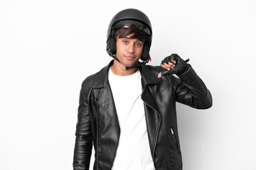 Young man with a motorcycle helmet isolated on white background showing thumb down with negative expression