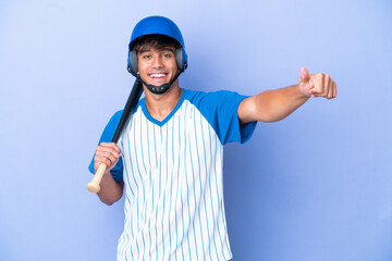 Baseball caucasian man player with helmet and bat isolated on blue background giving a thumbs up...